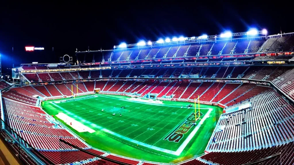 A panoramic night view of Levi's Stadium in Santa Clara, highlighting vibrant lights.