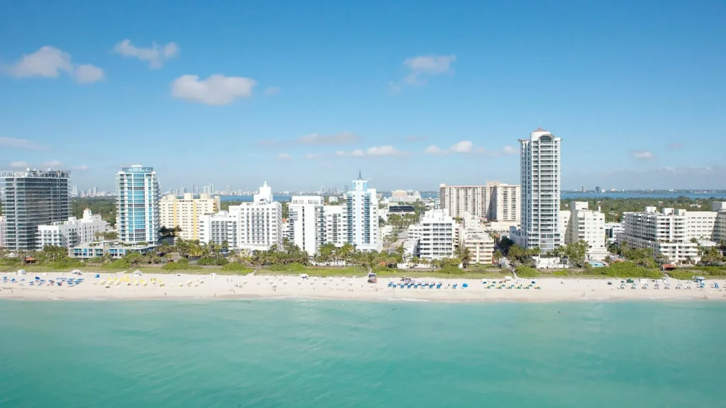 Stunning aerial view capturing the Miami Beach skyline and its pristine coastline under a clear blue sky.