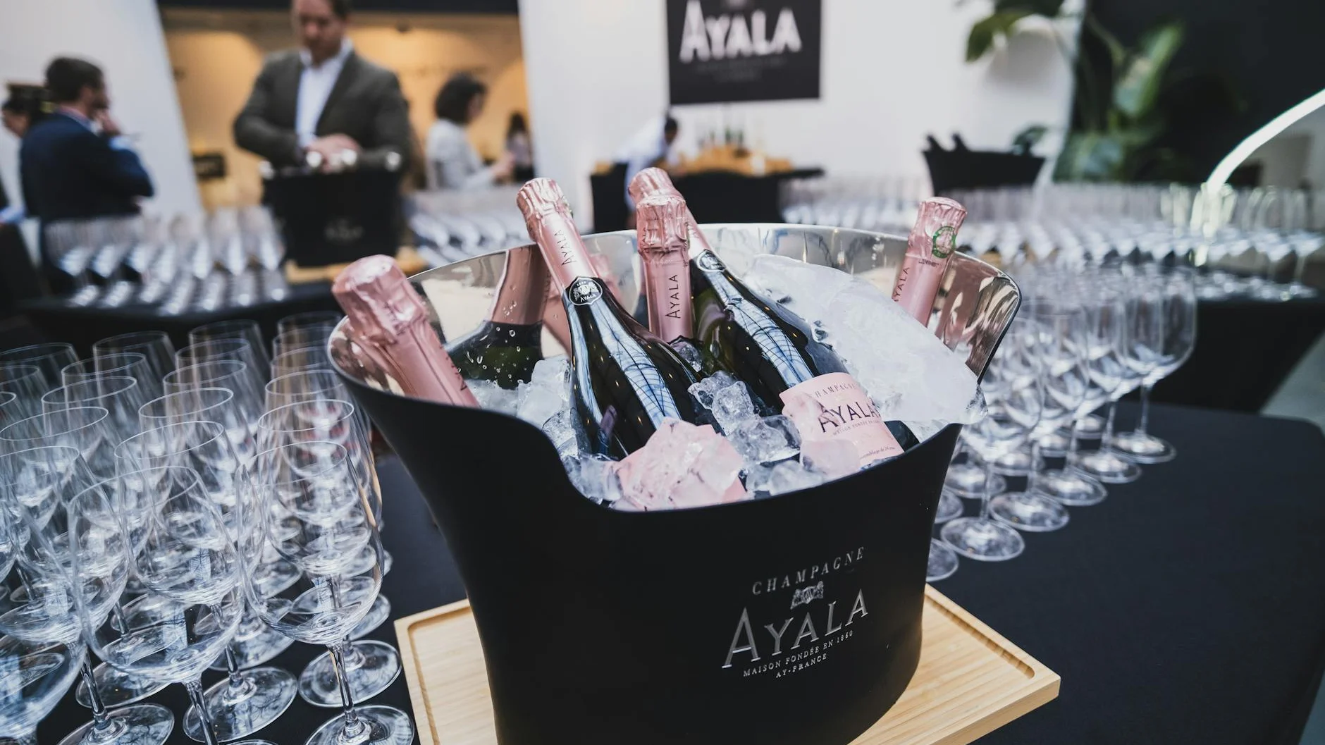 Champagne bottles in ice bucket with crystal glasses at a VIP hospitality event, representing premium Kentucky Derby packages
