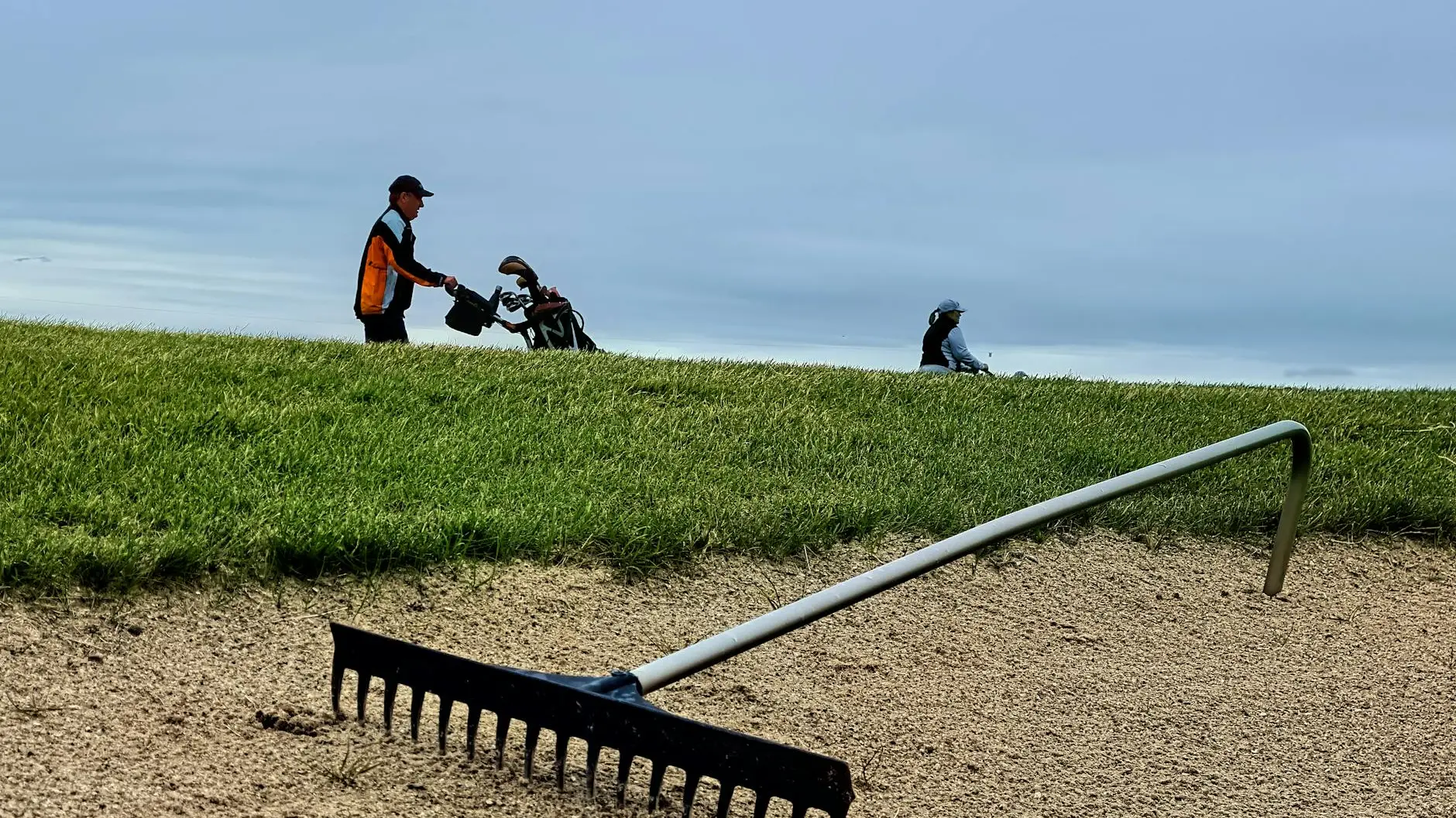 Spectators walking along a championship golf course pathway during a spring tournament