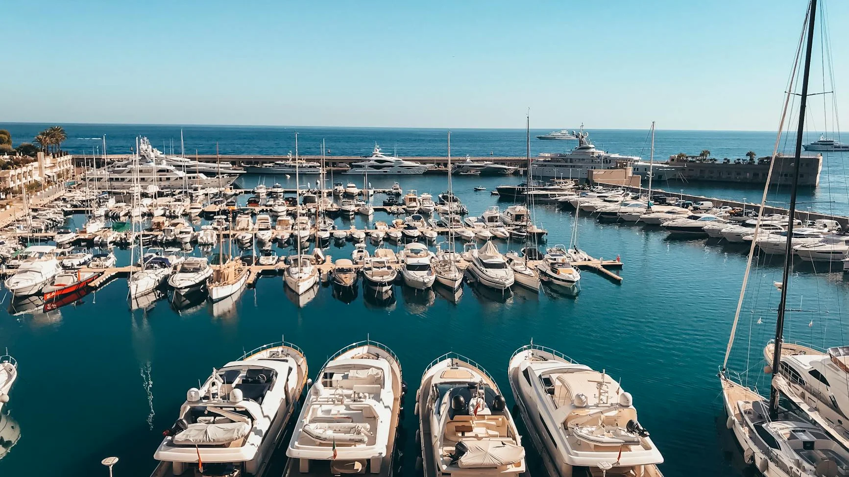 Luxury superyachts in Monaco Port Hercule harbor during the Formula 1 Grand Prix weekend