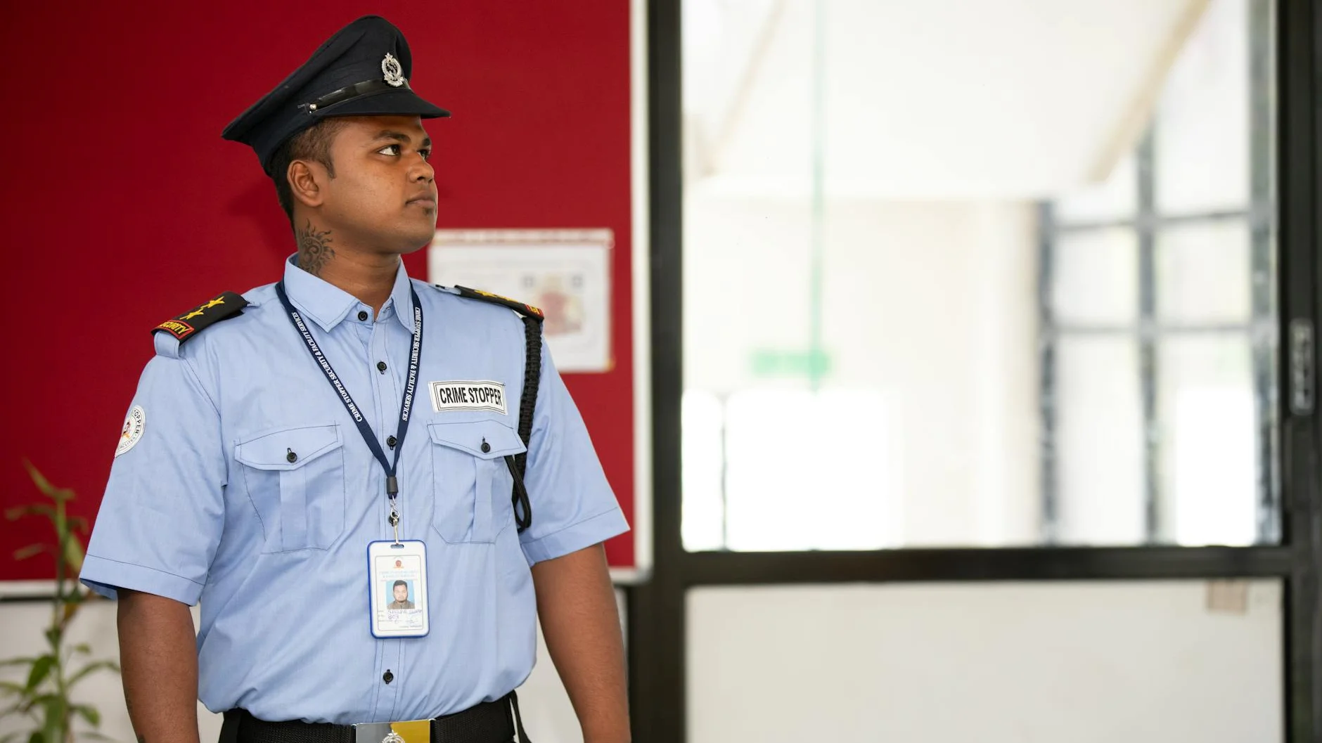 Professional security guard standing at building entrance providing executive protection