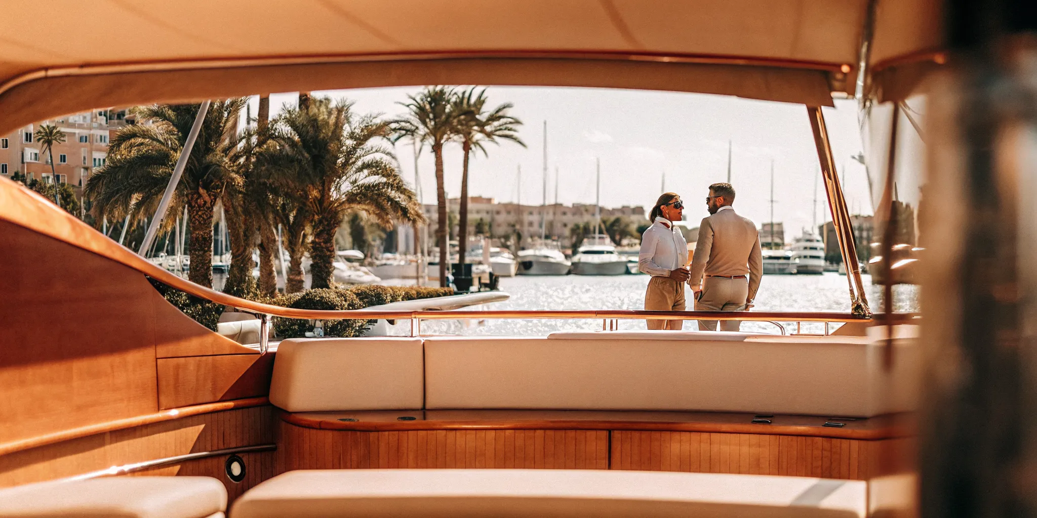 Luxury yacht docked in Cannes with French Riviera coastline