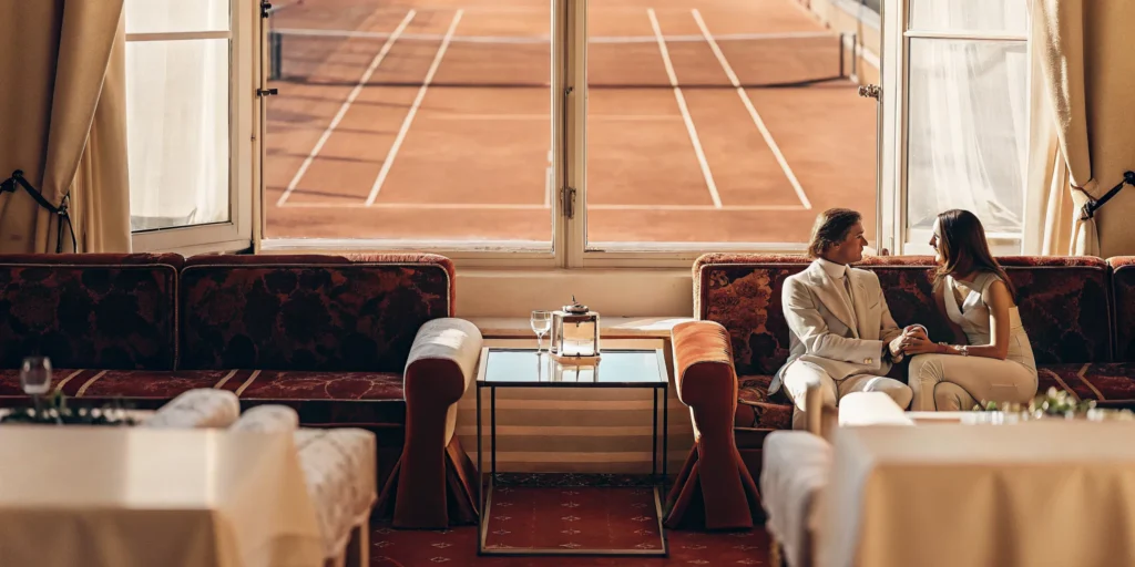 Luxury French Open hospitality lounge overlooking a clay tennis court