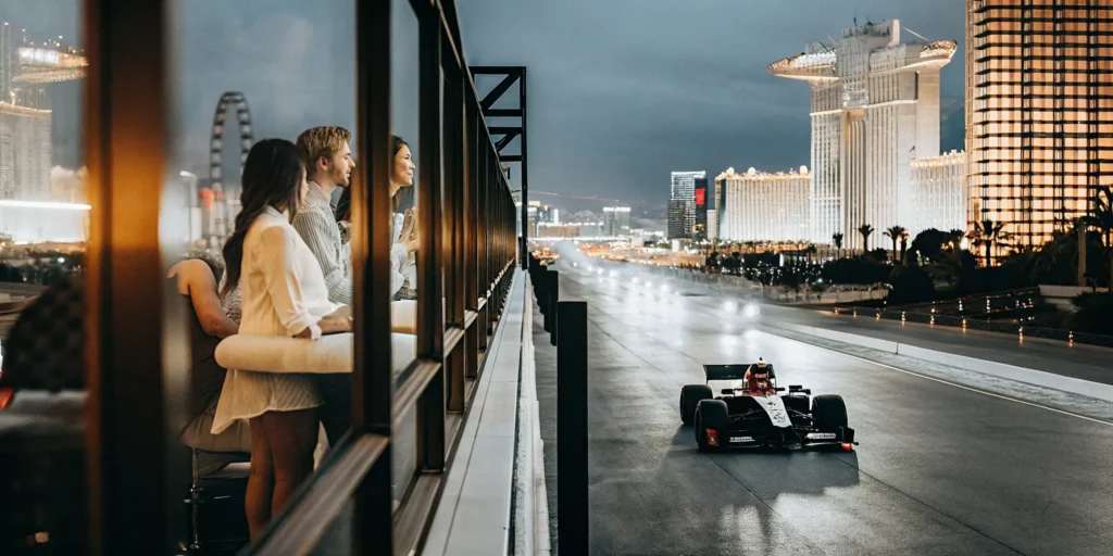 Las Vegas Strip at night during F1 Grand Prix with luxury hospitality suites overlooking the track