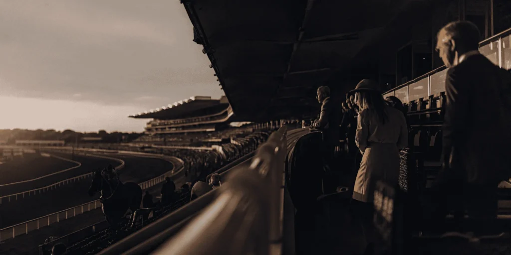 Luxury horse racing event at Keeneland with VIP hospitality areas and premium seating overlooking the track